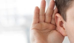 Hand behind ear trying to hear
