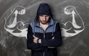 COVID-Resistant Super Humans - Young Man stands in front of Chalk Biceps