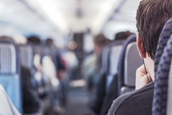 Seated Passengers Representing Covid-19 Travel Restrictions